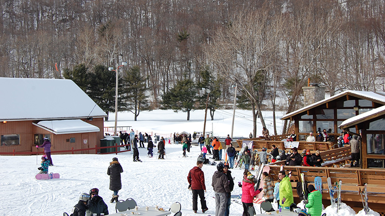 Winter sports enthusiasts enjoying a beautiful day at Victor Constant Ski Resort in Hudson Valley, New York. The resort is nestled amidst stunning winter scenery.