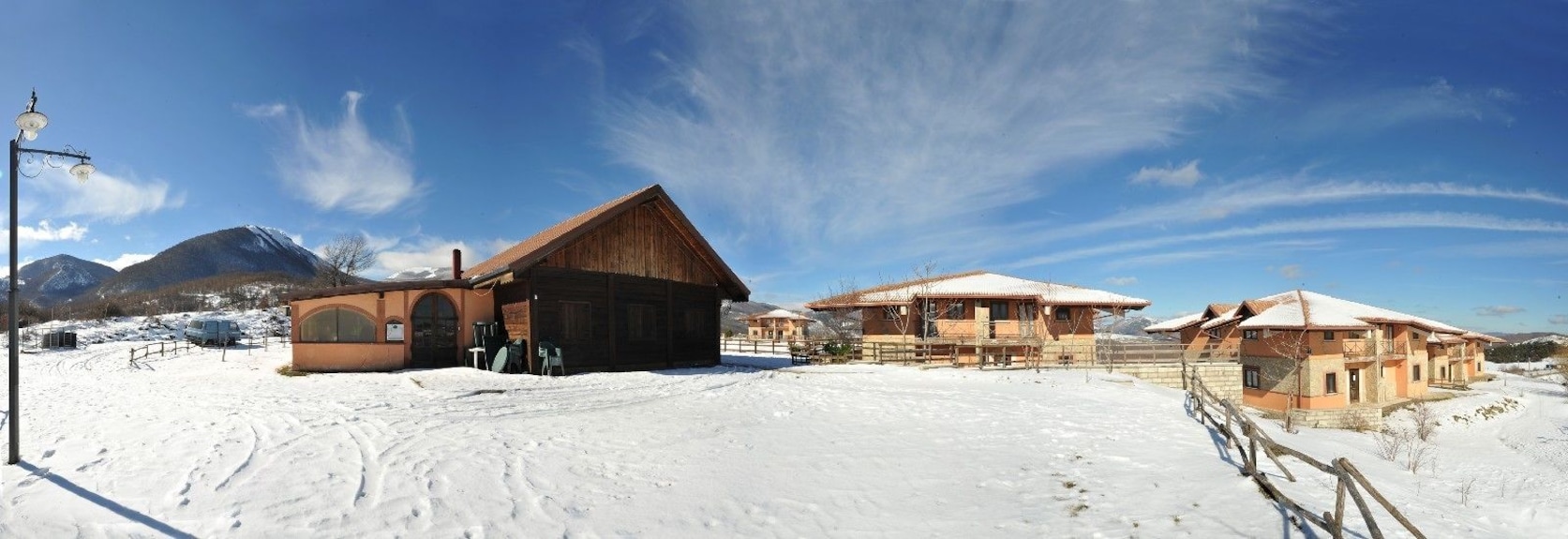Sellata in Italy - a house in the snow with mountains in the background.