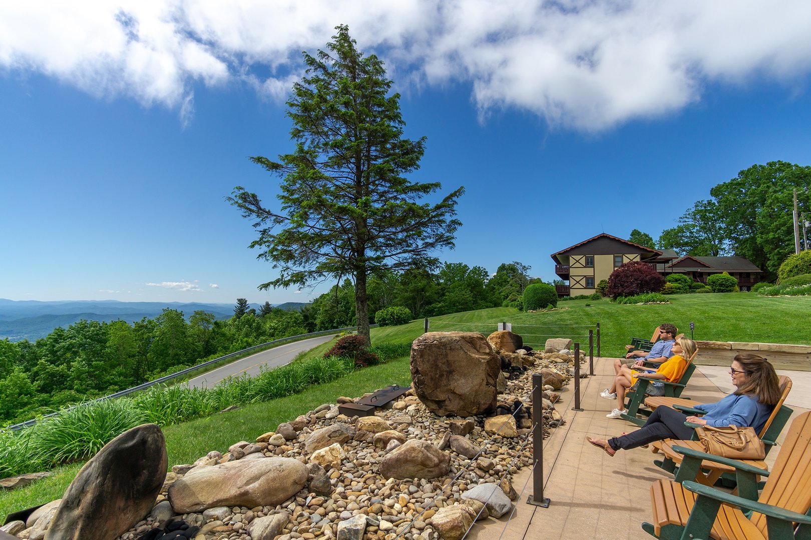 Little Switzerland in USA - two people sitting on chairs on a patio overlooking the mountains.