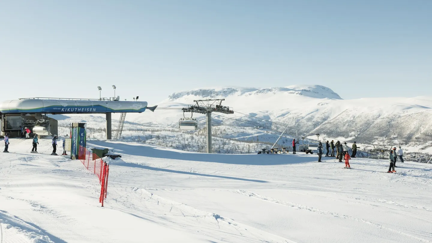 Geilo in Norway - a group of people standing on top of a ski slope.
