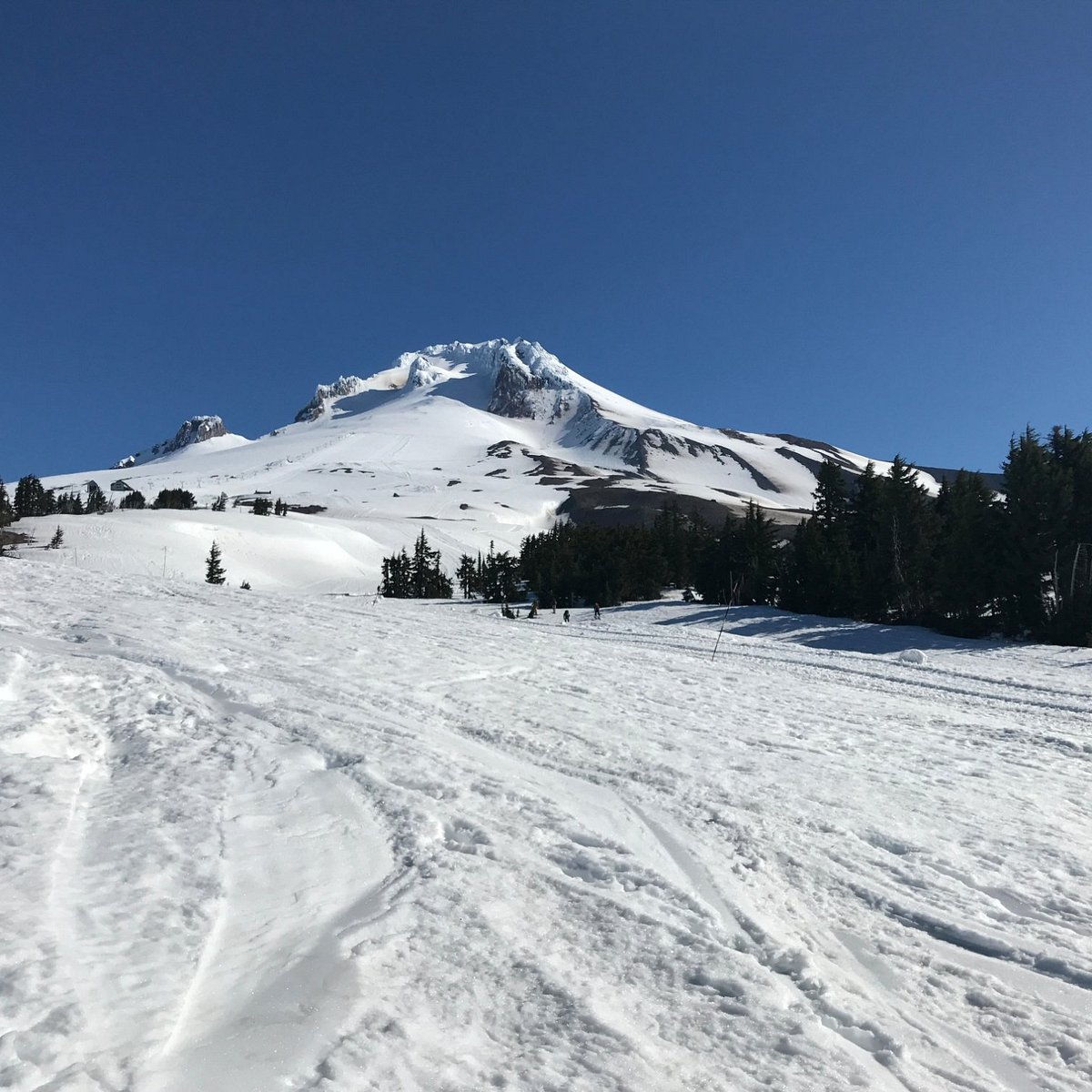 Timberline Summit Pass in USA - a snow covered ski slope with a mountain in the background.