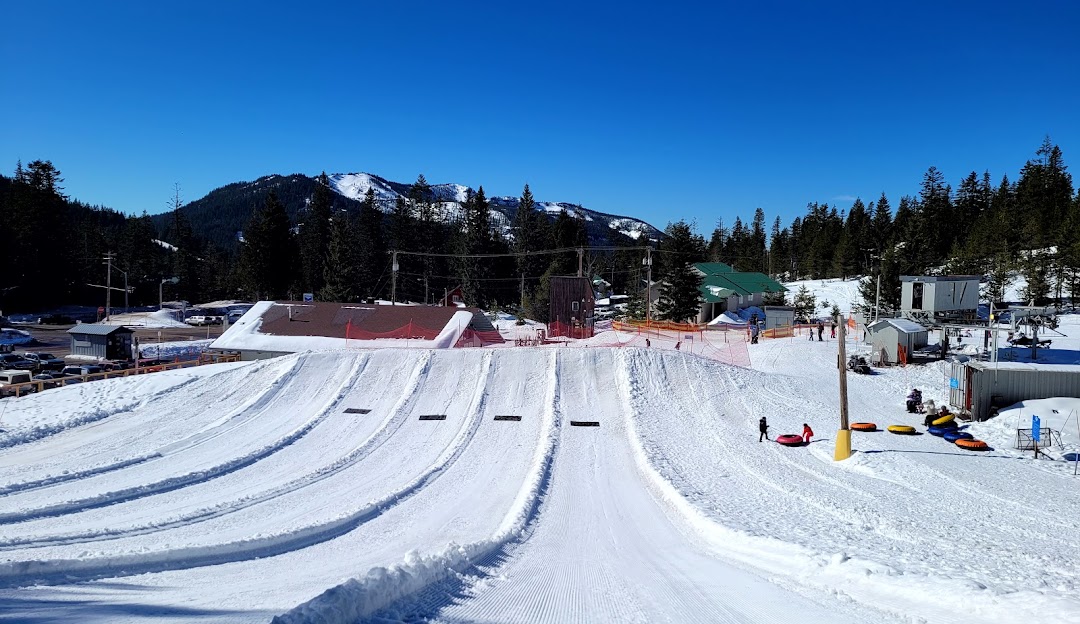 Winter sports scene at Timberline Summit Pass, Oregon featuring snow-covered slopes bustling with activities at the ski resort, filled with enthusiasts enjoying the day.