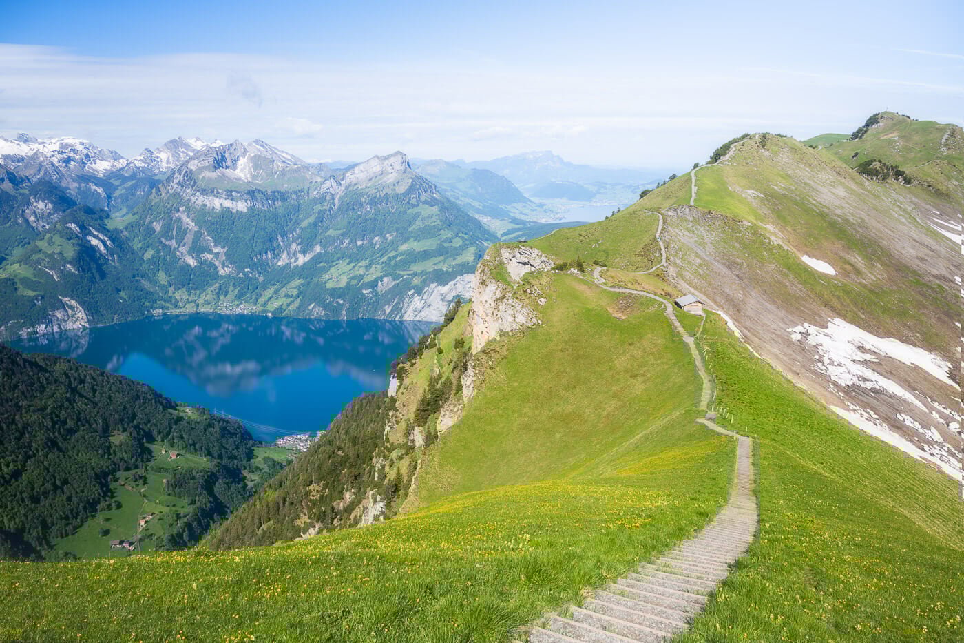 Stoos – Fronalpstock | ​Klingenstock in Switzerland - the path to the top of the mountain with a lake in the background.