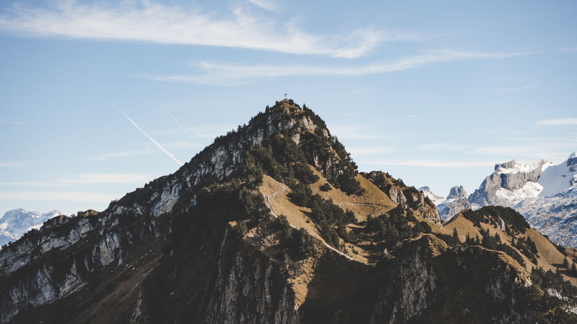 View of the majestic mountain in Stoos – Fronalpstock | Klingenstock Schwyz Central Switzerland featuring a distant chalet amidst the serene landscape.