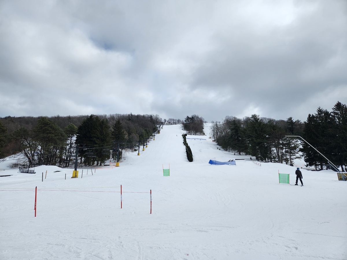 Tussey Mountain in USA - a person on a snowboard going down a hill.