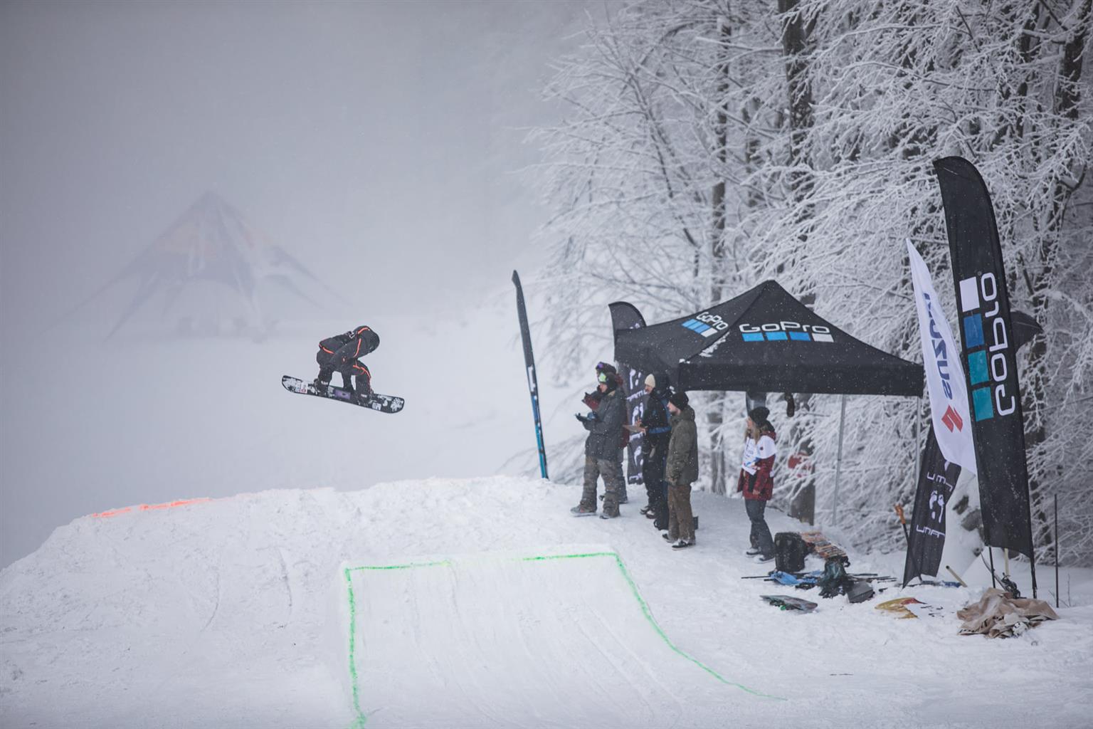 Suior in Romania - a person jumping in the air on a snowboard.