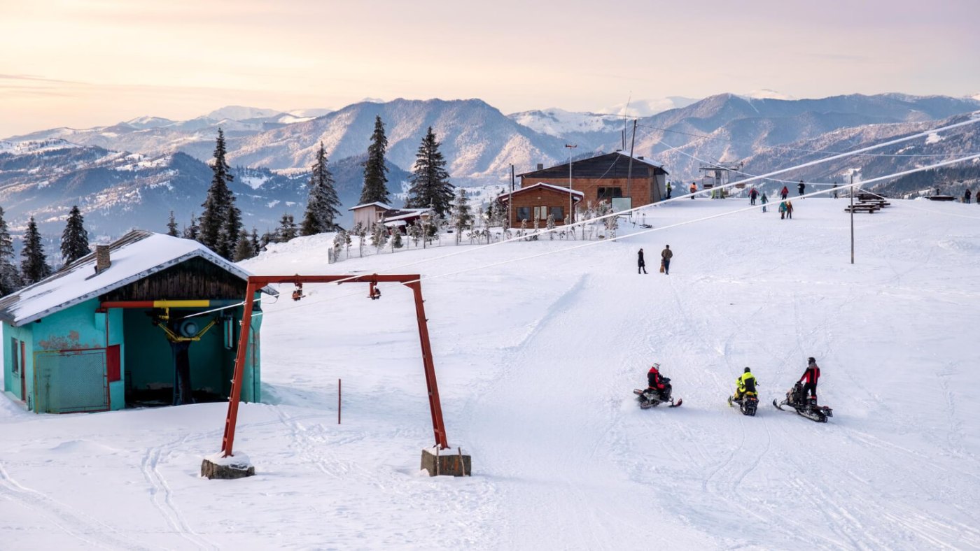 Suior in Romania - a group of people riding down a snow covered slope.