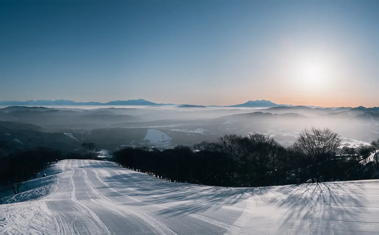Motai in Japan - the sun is shining over the snow covered mountains.