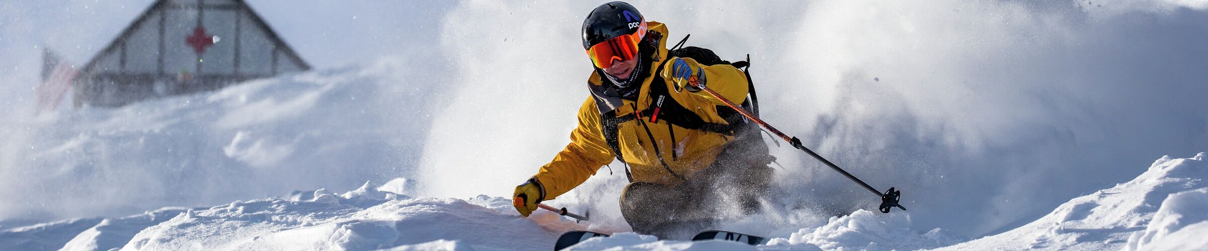 Solitude in USA - a man in a yellow jacket skiing down a mountain.