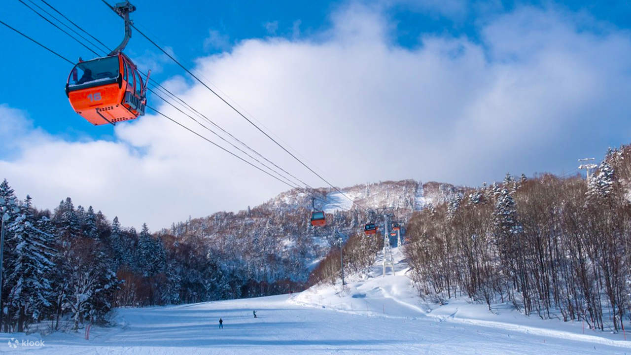 Asarigawa Onsen in Japan - a ski lift going up a snowy slope.