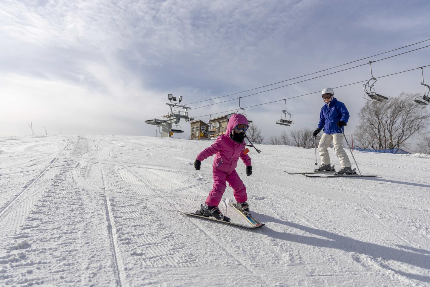 Great Bear Ski Valley in USA - two people are skiing down a snowy hill.