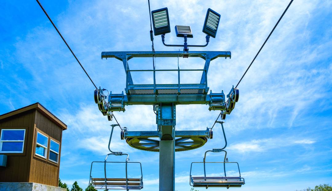 A scenic winter landscape at Great Bear Ski Valley in South Dakota focusing on a prominent ski lift against the snowy backdrop.