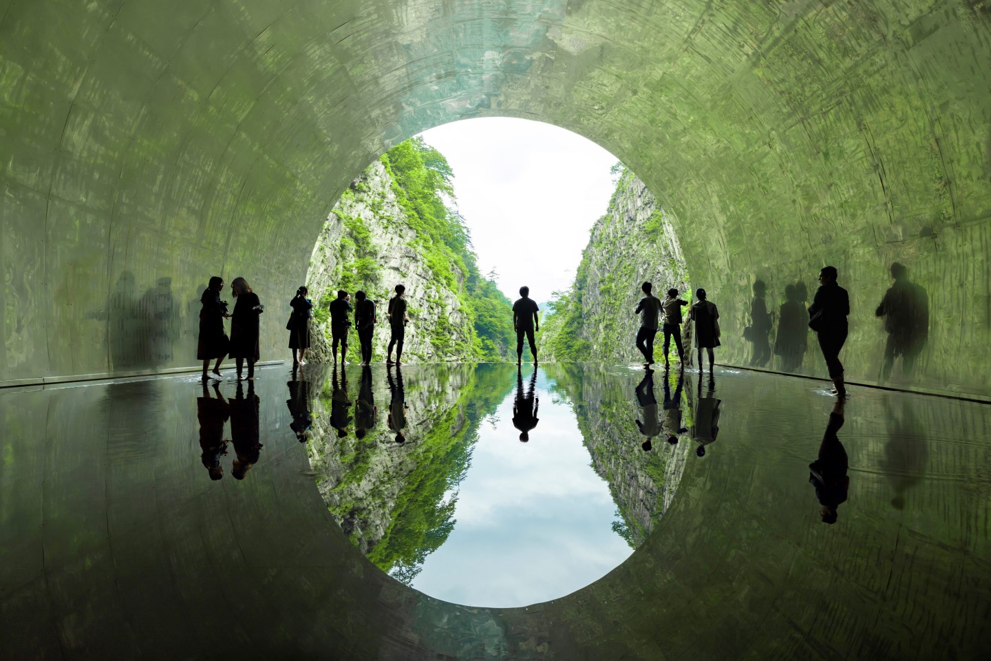 Nakasato Kiyotsu in Japan - people walking through a tunnel in the forest.