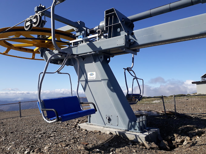 Bruncu Spina in Italy - a blue chair sitting on top of a mountain.