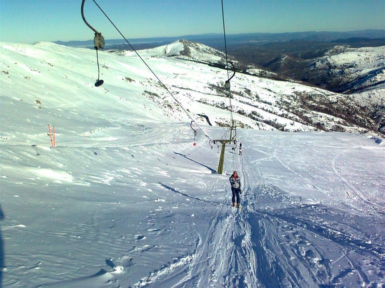 Bruncu Spina in Italy - a person riding a ski board down a snowy slope.