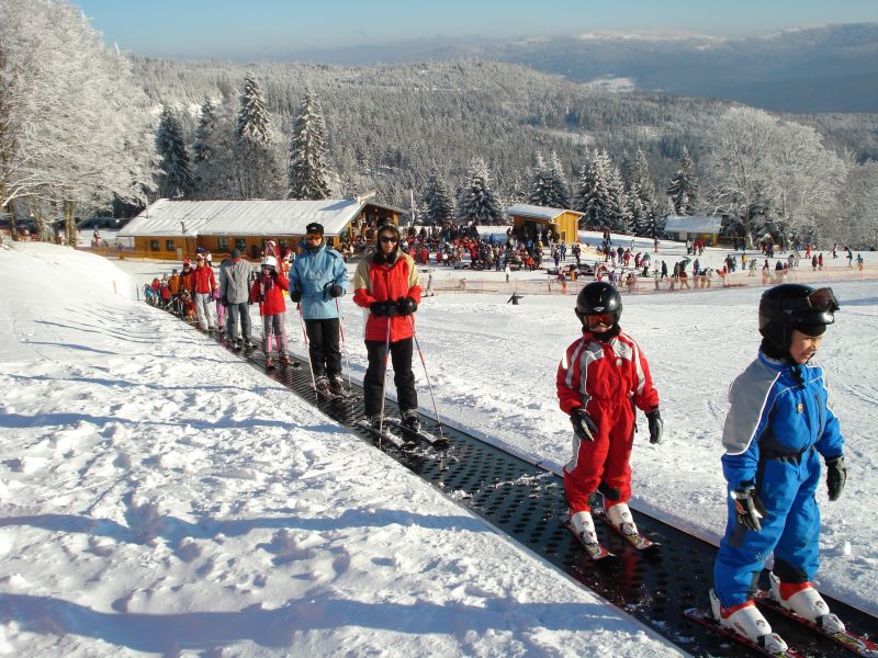 Arber in Germany - a group of people skiing down a snow covered slope.
