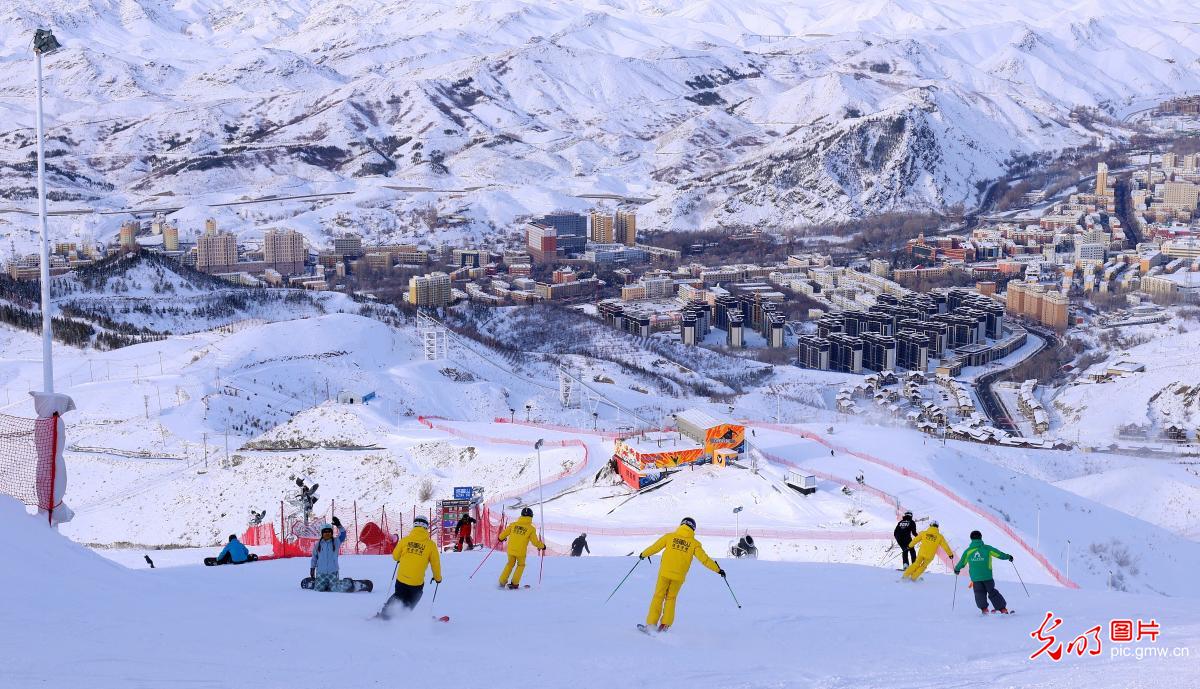 Jinlongshan – Zhalantun in China - a group of people skiing down a mountain.