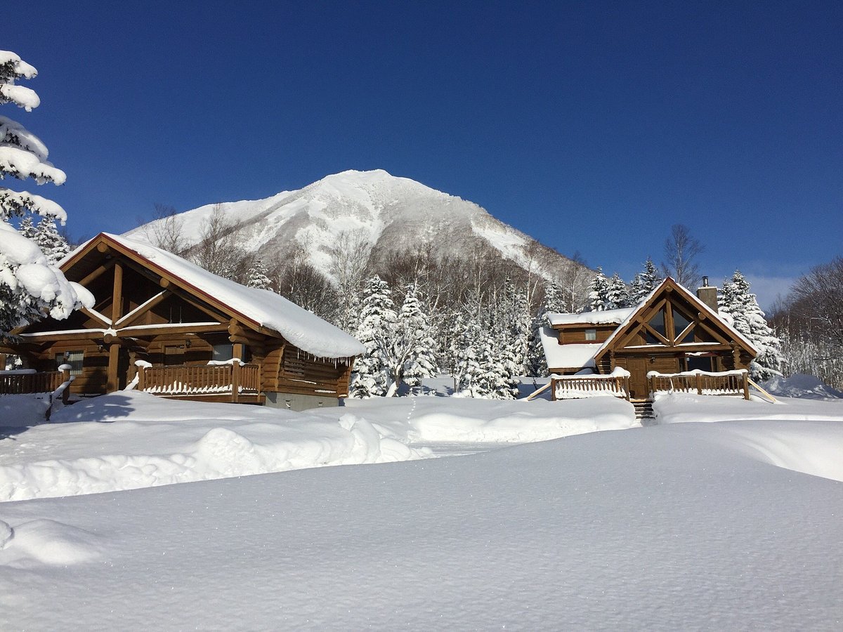 Nakayamatoge Kogen in Japan - a house in the snow with mountains in the background.