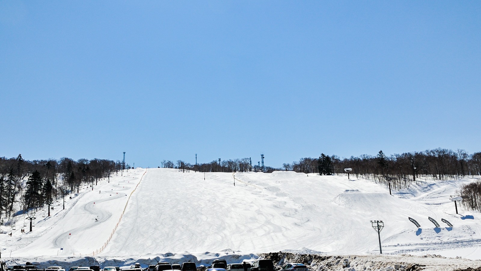 Nakayamatoge Kogen in Japan - a group of people riding ski boards down a hill.