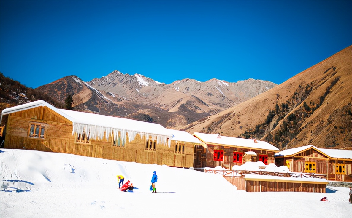 Jiudingshan Taiziling in China - a group of people skiing down a snowy slope.