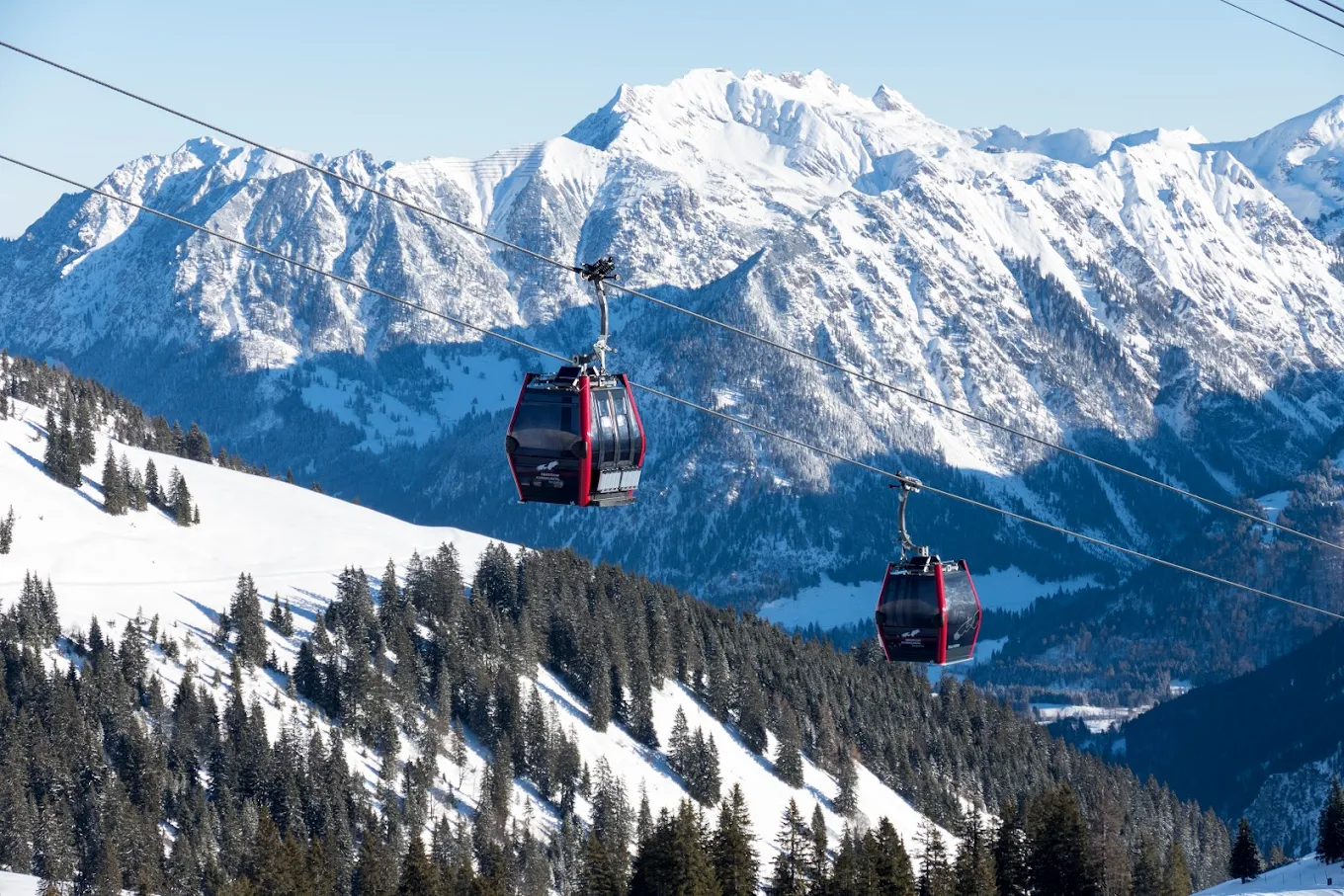 Fellhorn | ​Kanzelwand – Oberstdorf | ​Riezlern in Germany - a ski lift going up a snowy mountain.