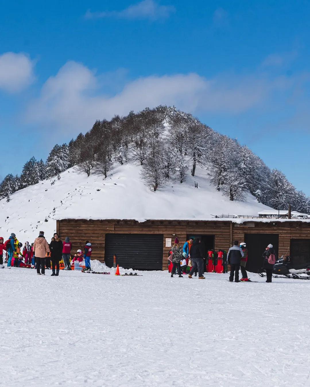 Anilio in Greece - a group of people standing on top of a snow covered mountain.