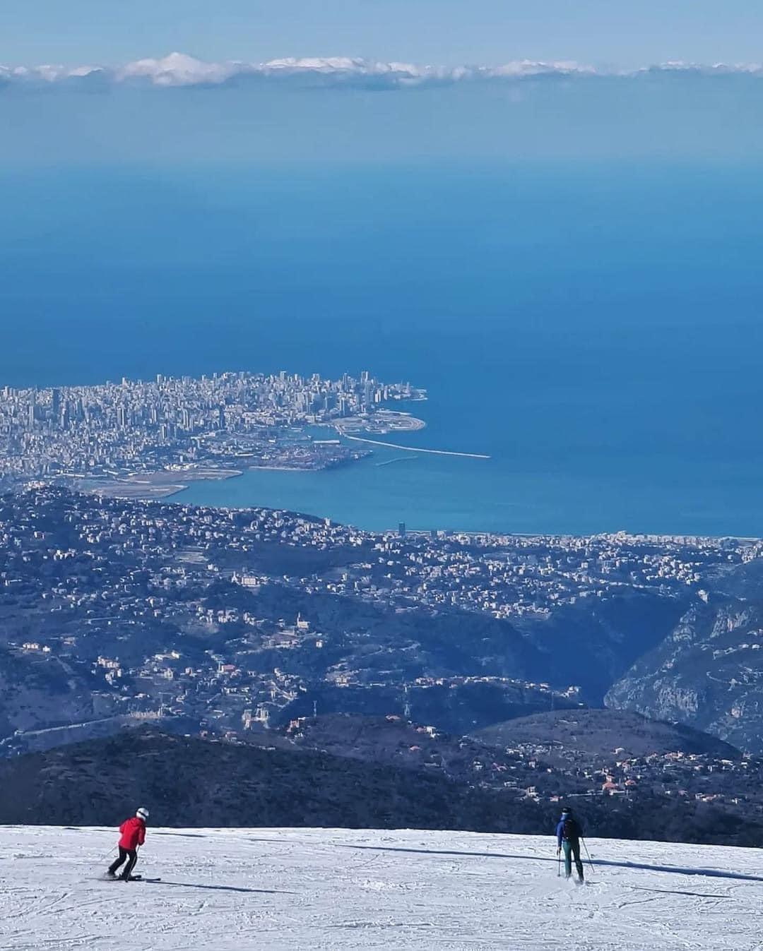 Faqra in Lebanon - two people are skiing down a snowy hill.