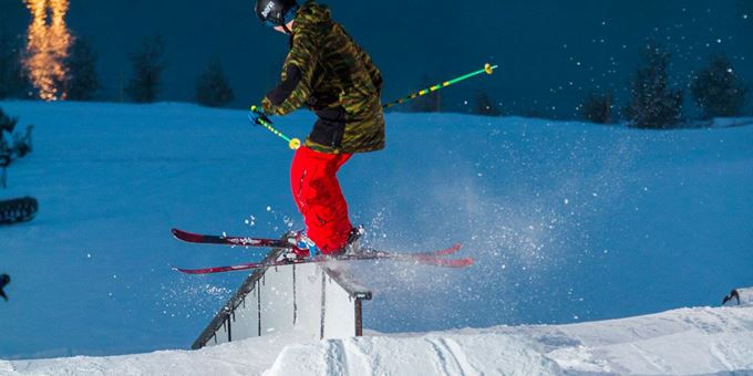 A snowboarder enjoying an adventurous ride at the Sunburst ski area in Wisconsin USA; vividly bringing life to the cold winter landscape.