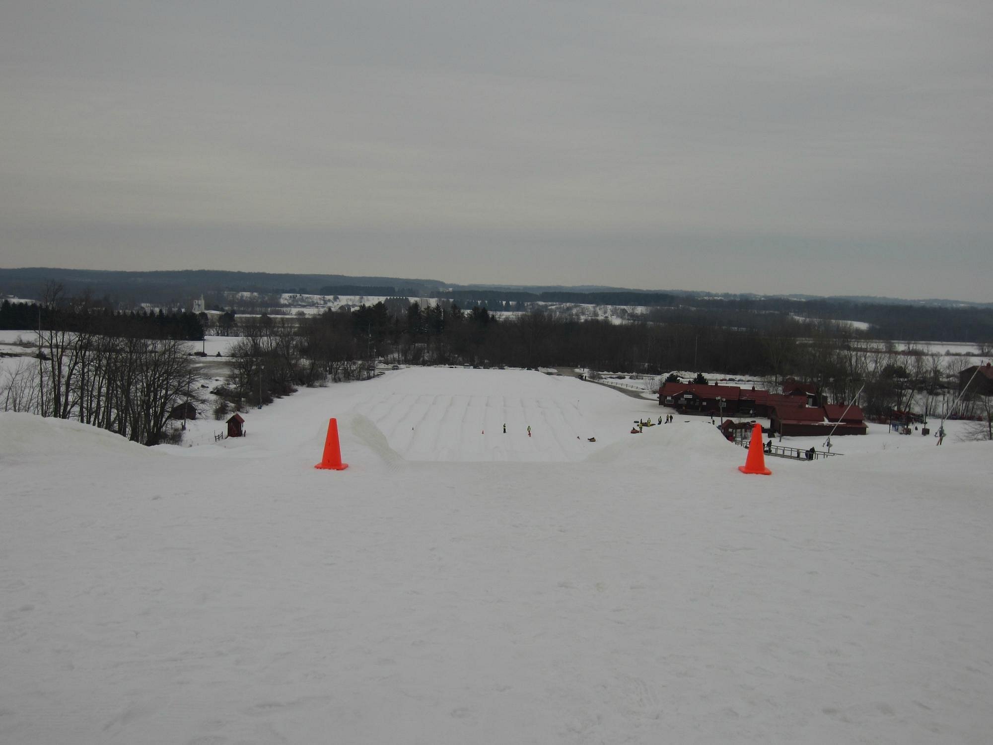 A skier enjoying a day at the Sunburst winter sports center in Wisconsin USA. The scene showcases a stunning view of the snow-covered slopes at the ski resort.