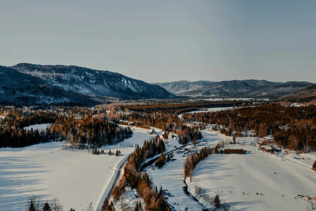 A captivating winter sports scene at a ski resort in Saint-Raymond Capitale-Nationale Quebec Canada characterized by dazzling snow-covered landscape. Skiers can be seen enjoying the winter sport.