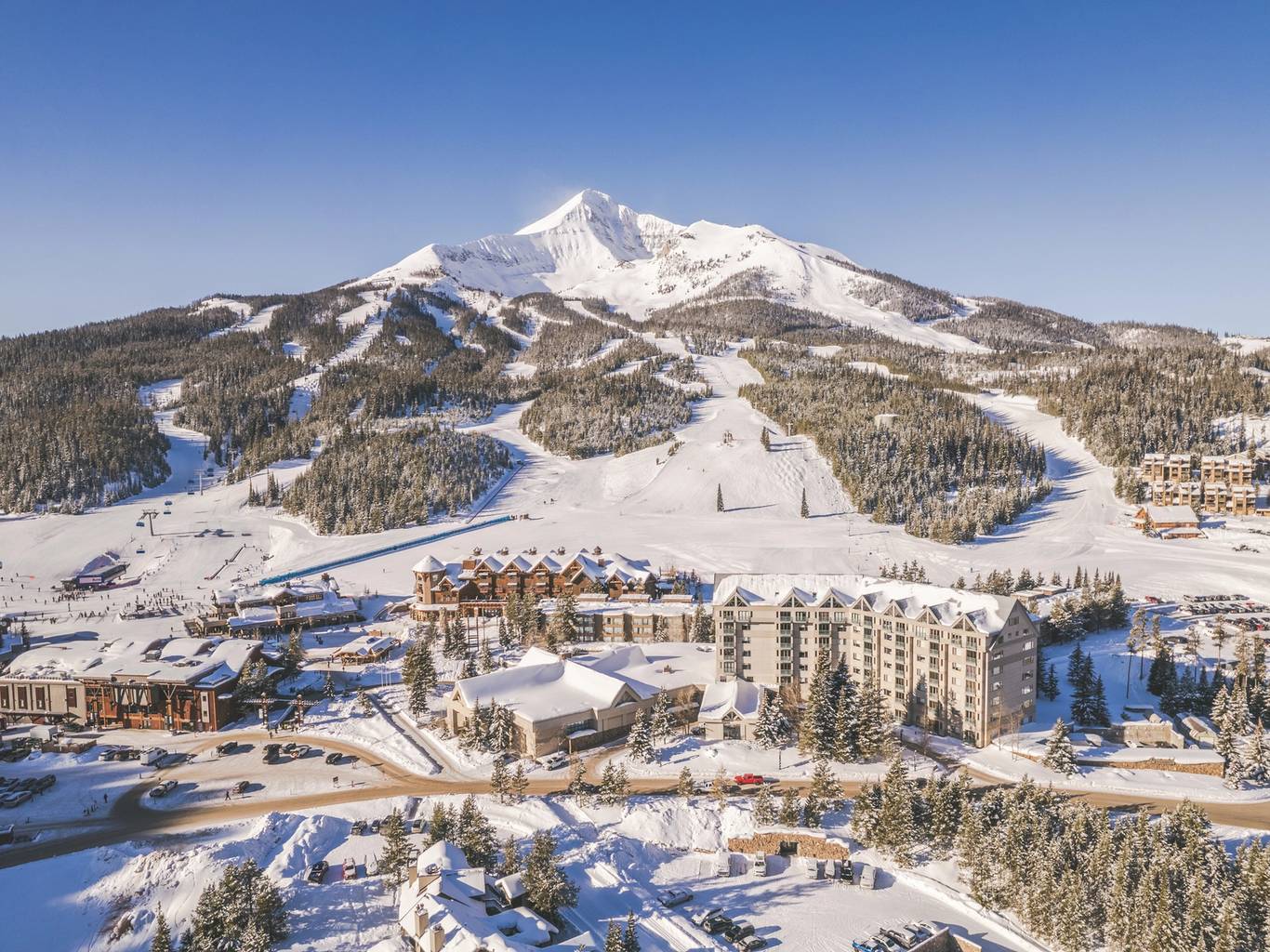 Big Sky Resort in USA: a ski resort surrounded by snow covered mountains.