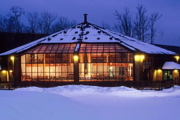 View of a cozy lodge nestled in the snowy landscape of Eagle Rock, Hazleton, Pennsylvania, featuring the winter sports center and ski resort, surrounded by pristine winter scenes.