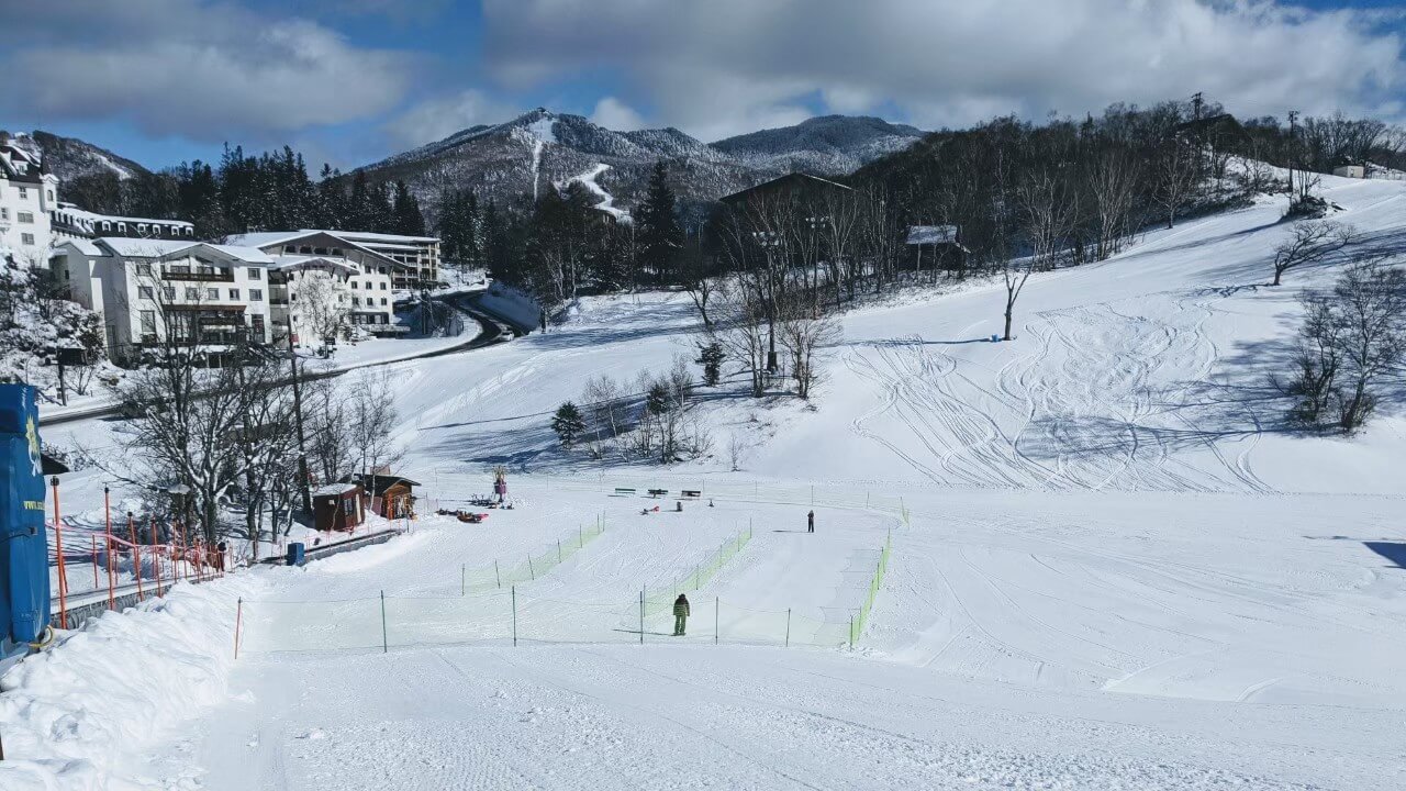 Maruike in Japan: a snow covered ski slope with a building in the background.