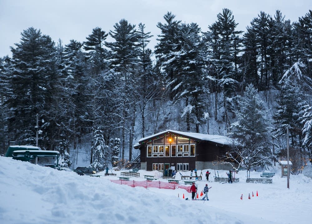 Winter scene at Chester Bowl in Minnesota, USA, highlighting an active winter sports scene. A winter sports centre and ski resort create a stunning winter scenery amid snow-covered landscape.