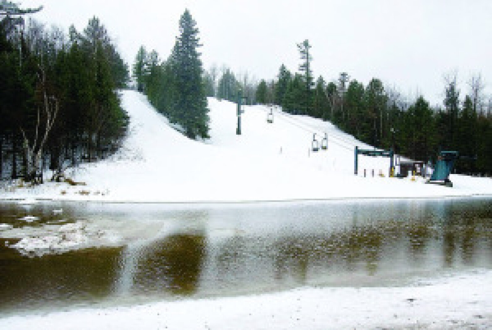 Chester Bowl in USA - a snow covered ski slope with trees in the background.