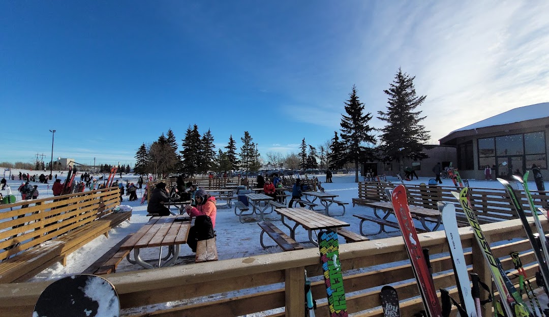 Winter sports scene at Sunridge ski resort in Edmonton, Alberta, Canada, featuring ski lifts and stunning snowy landscape.