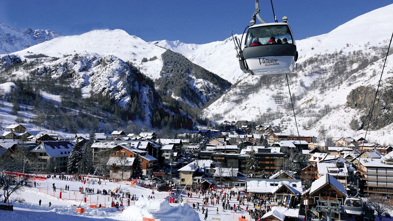 Ski resort Valloire - Galibier-Thabor in France - a ski lift carrying skiers up a mountain.