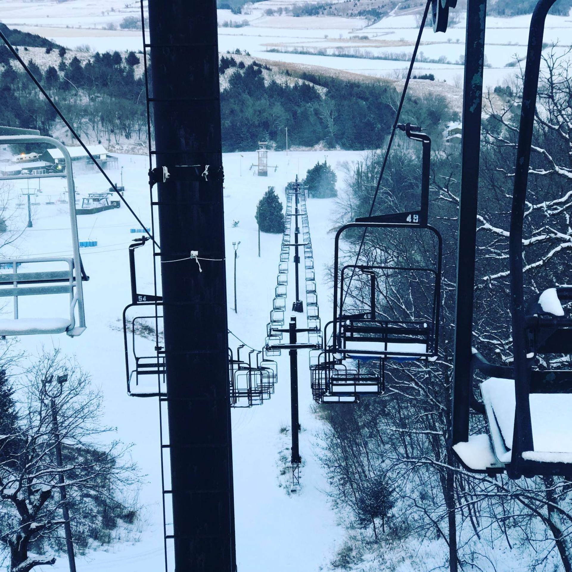 A picturesque winter landscape at Mt Crescent Iowa USA featuring a ski lift and resort. Skiers relish in the winter sports scene amid a breathtaking snowy backdrop.