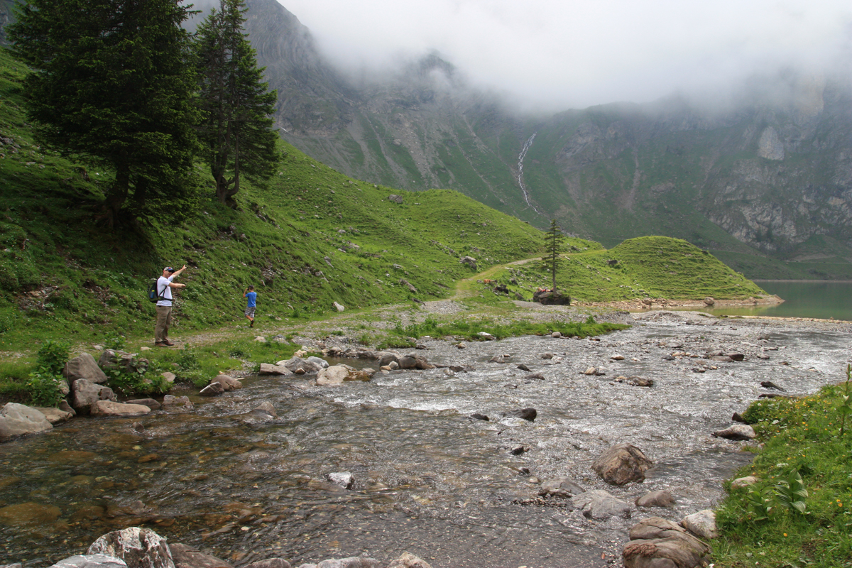 Bannalp – Oberrickenbach in Switzerland - a man standing in the middle of a river.