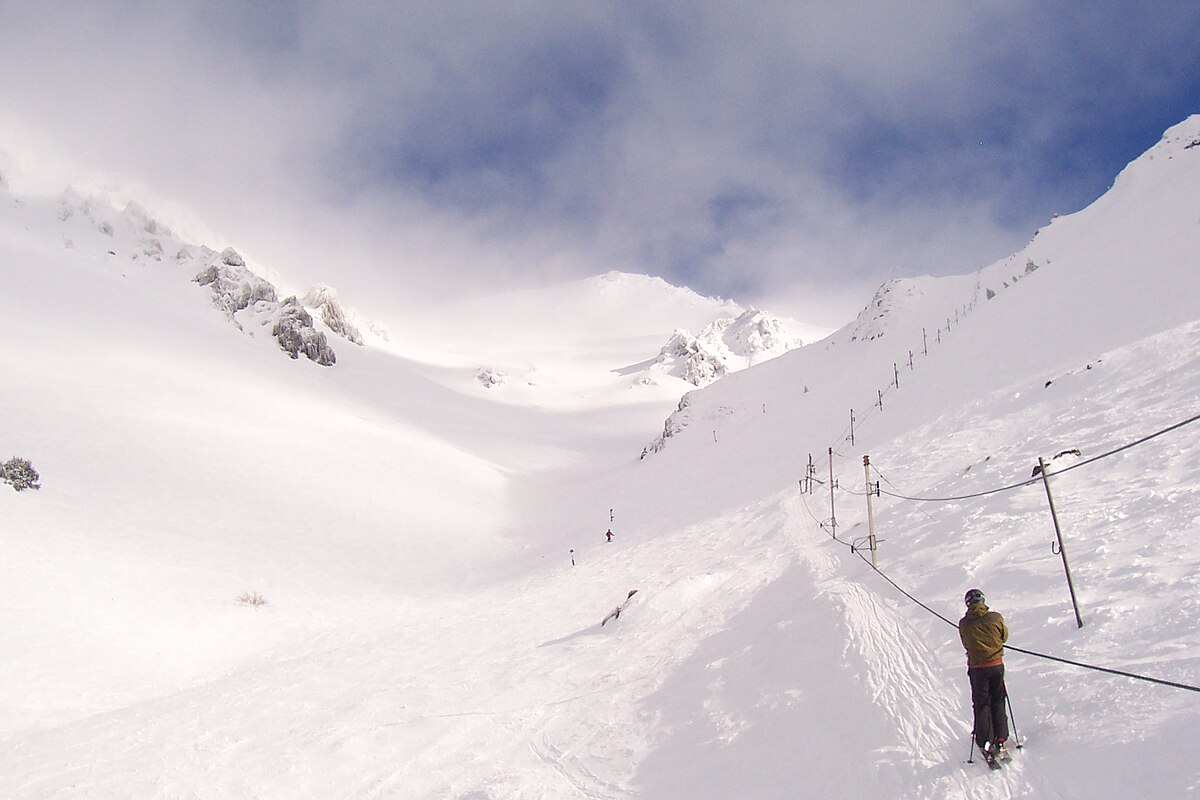 Craigieburn in New Zealand - a person is skiing down a snowy mountain.