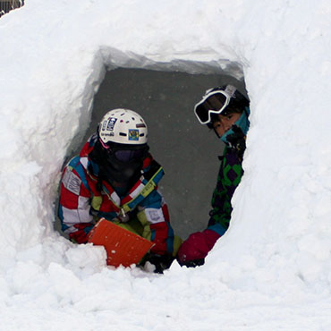 Uenono in Japan - a group of kids playing in a snow tunnel.