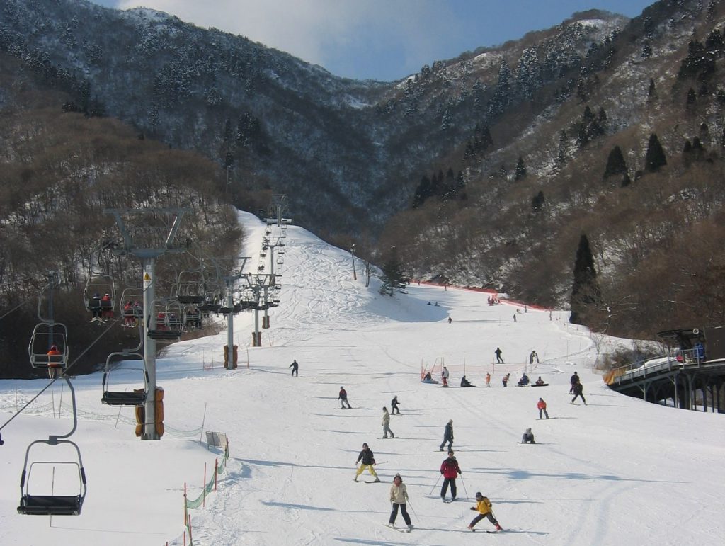 Kutsuki in Japan - a group of people skiing down a mountain.