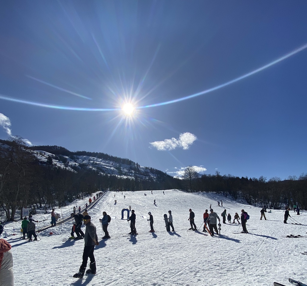 Lago Hermoso in Argentina - a group of people skiing down a snow covered hill.