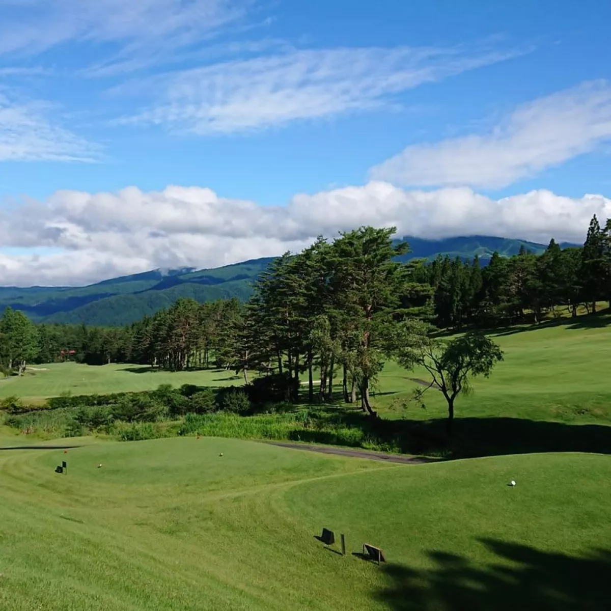 Shokawa Kogen in Japan - a golf course with mountains in the background.