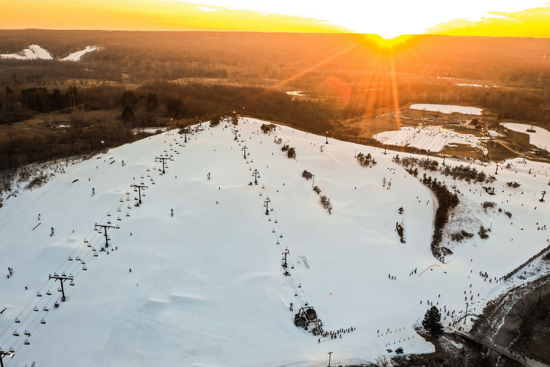 Uplands Ski Centre in Canada: an aerial view of a ski resort at sunset.