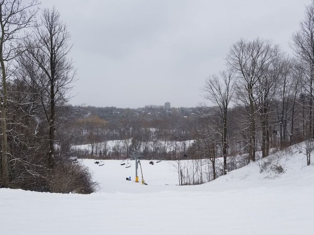 Winter scene at Uplands Ski Centre in Southern Ontario, Canada, showcasing the snow-covered slopes bustling with winter sports enthusiasts.