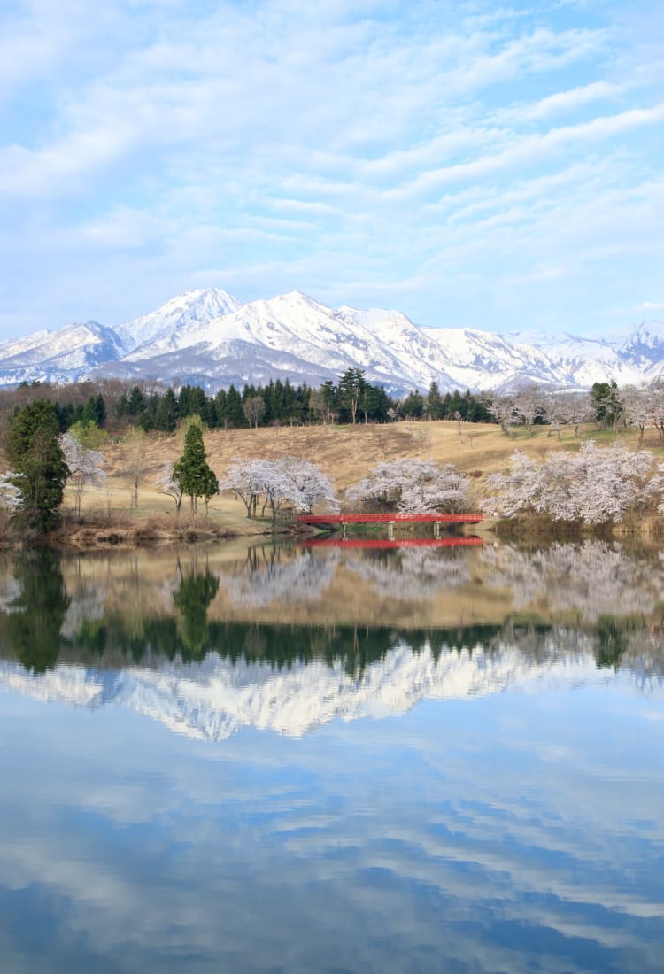 Kanayasan in Japan - a lake with snow capped mountains in the background.