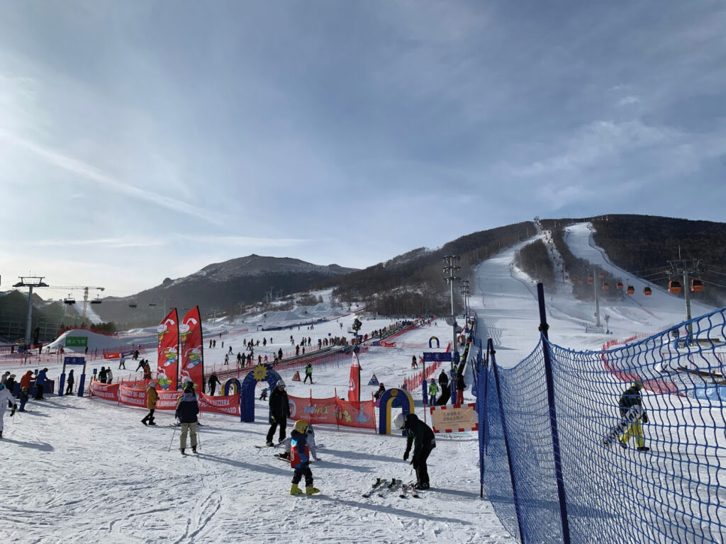 Jihua in China - a group of people skiing down a snowy slope.