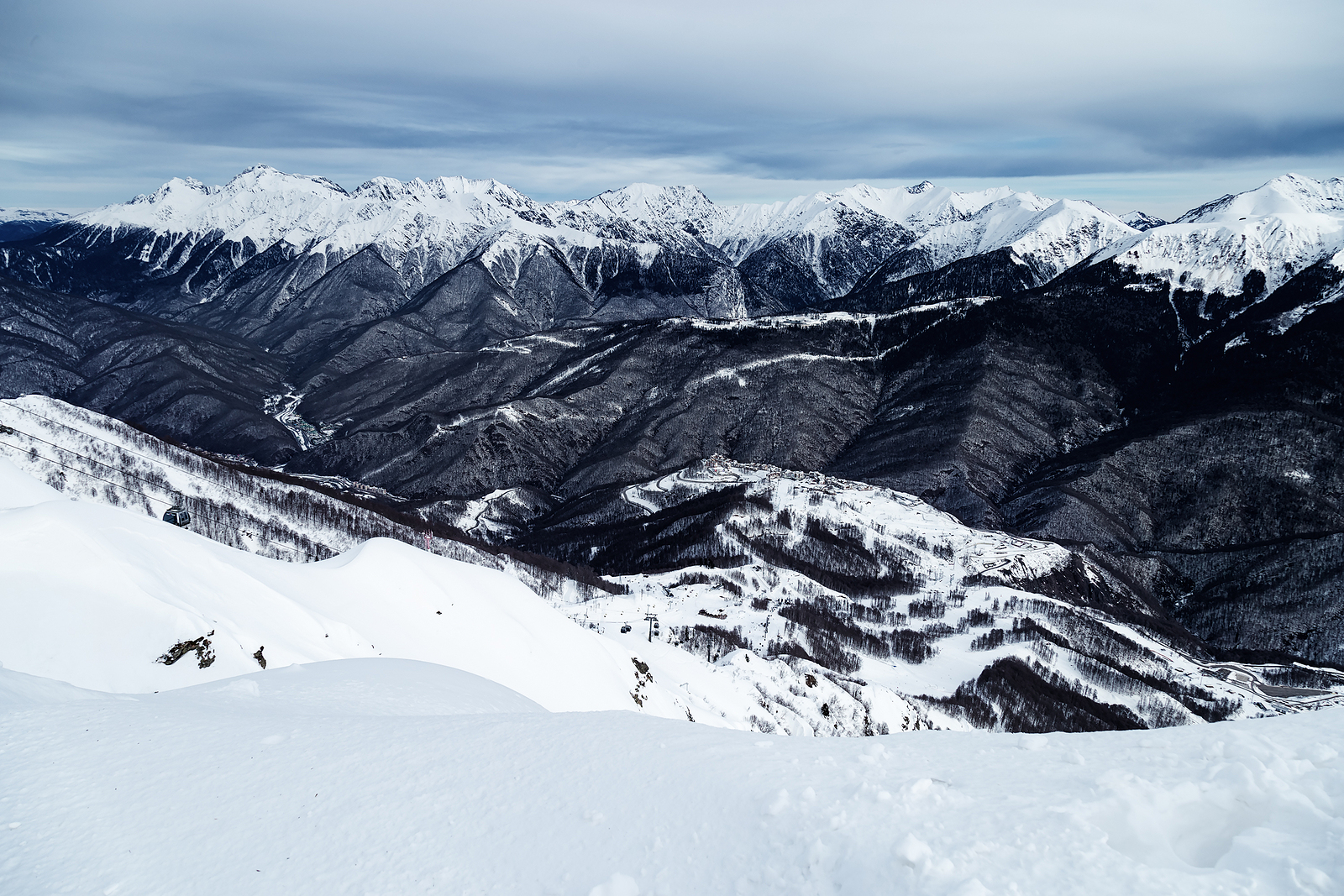 Dolina Vasta in Russia - a person skiing down a snowy mountain.