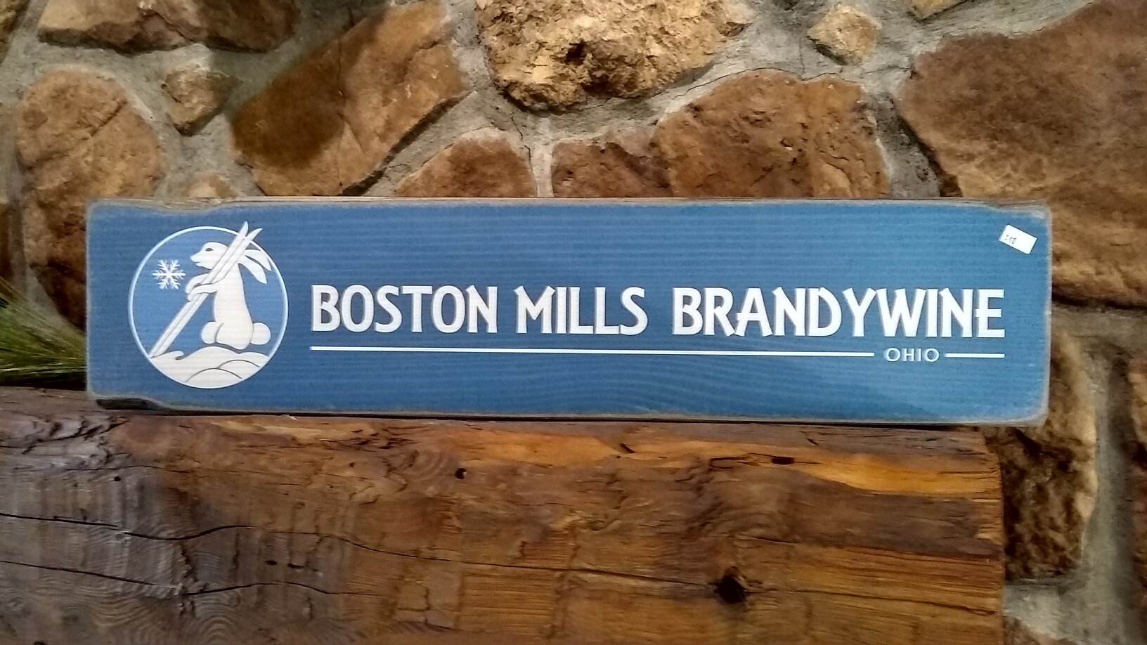 Brandywine in USA - a wooden sign sitting on top of a stone wall.